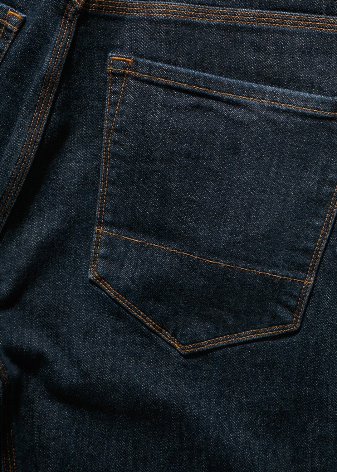 dark wash denim with accented copper stitching and trims